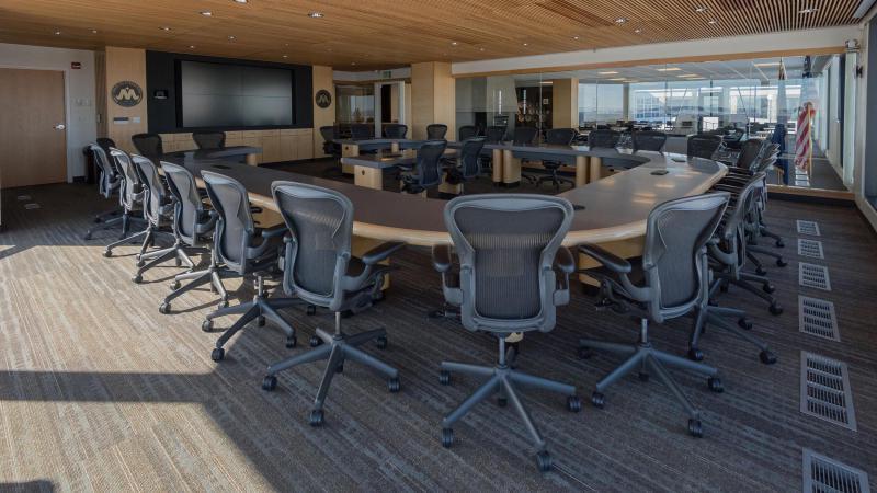 The Harold Schafer Leadership Center Boardroom features a large monitor at the front of the room with seating for several executives.